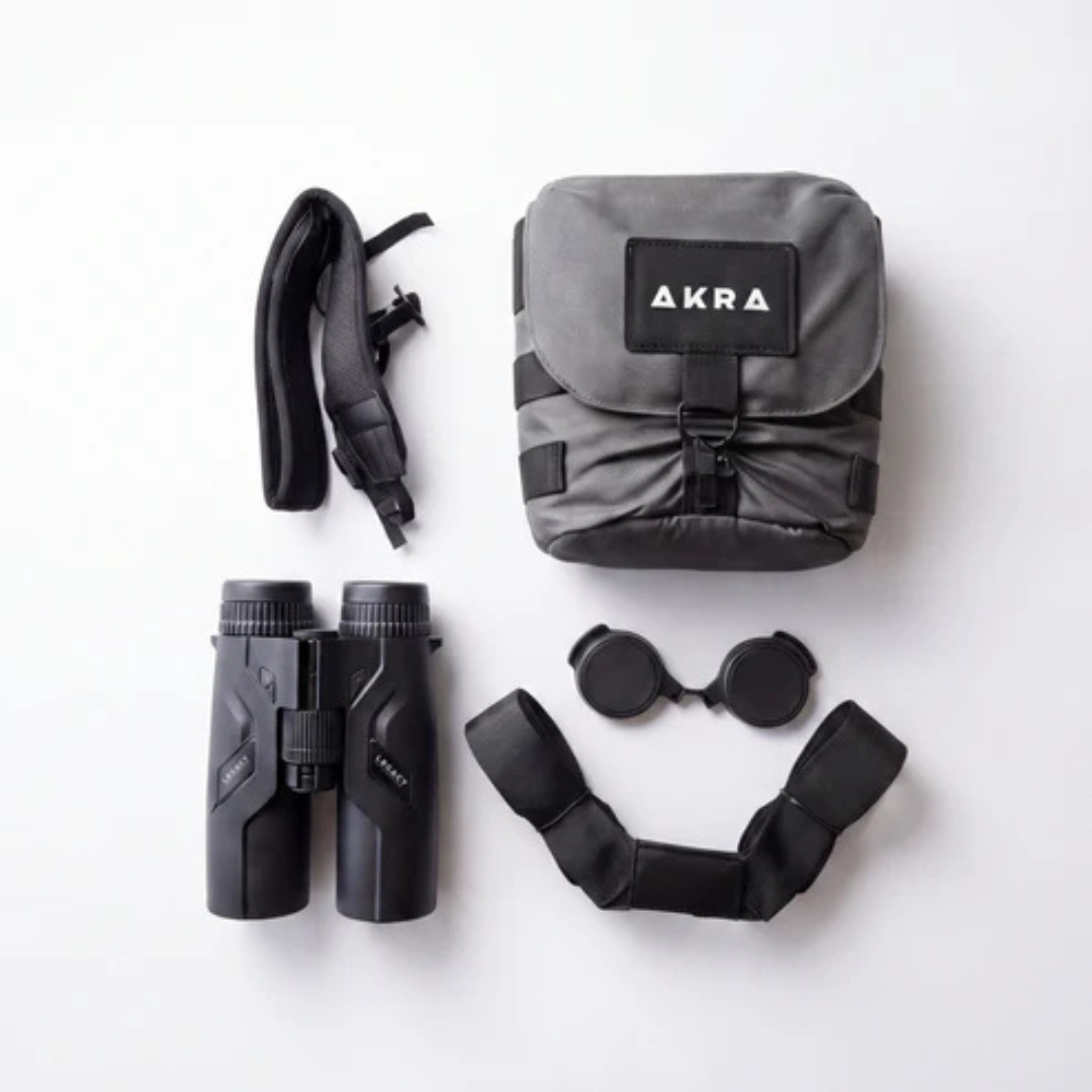 AKRA Legacy 10x42 RF binoculars included accessories layout including chest pack and straps.