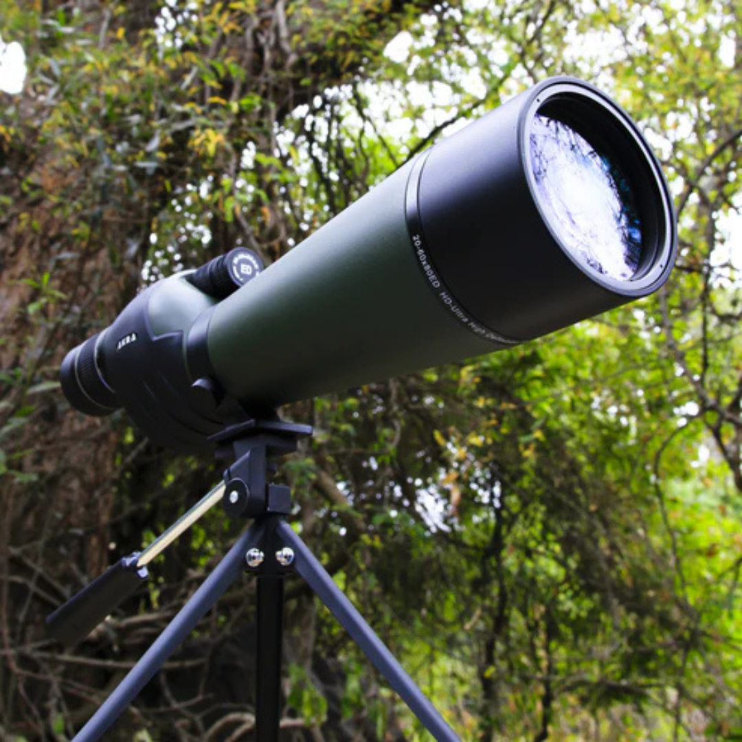 AKRA Legacy ED 20-60x80 spotting scope mounted on a tripod outdoors in nature.