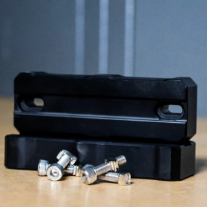 Pair of black Monster Weights M-LOK chassis weights stacked with included mounting bolts.